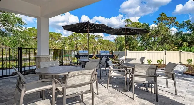 a view of a house with backyard and sitting area