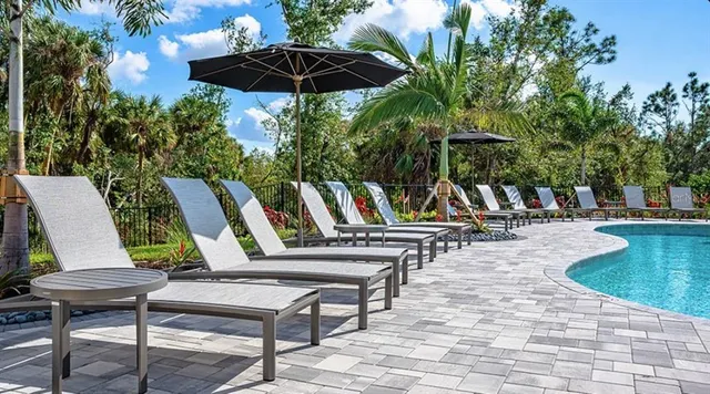 an aerial view of a house with a garden and lake view