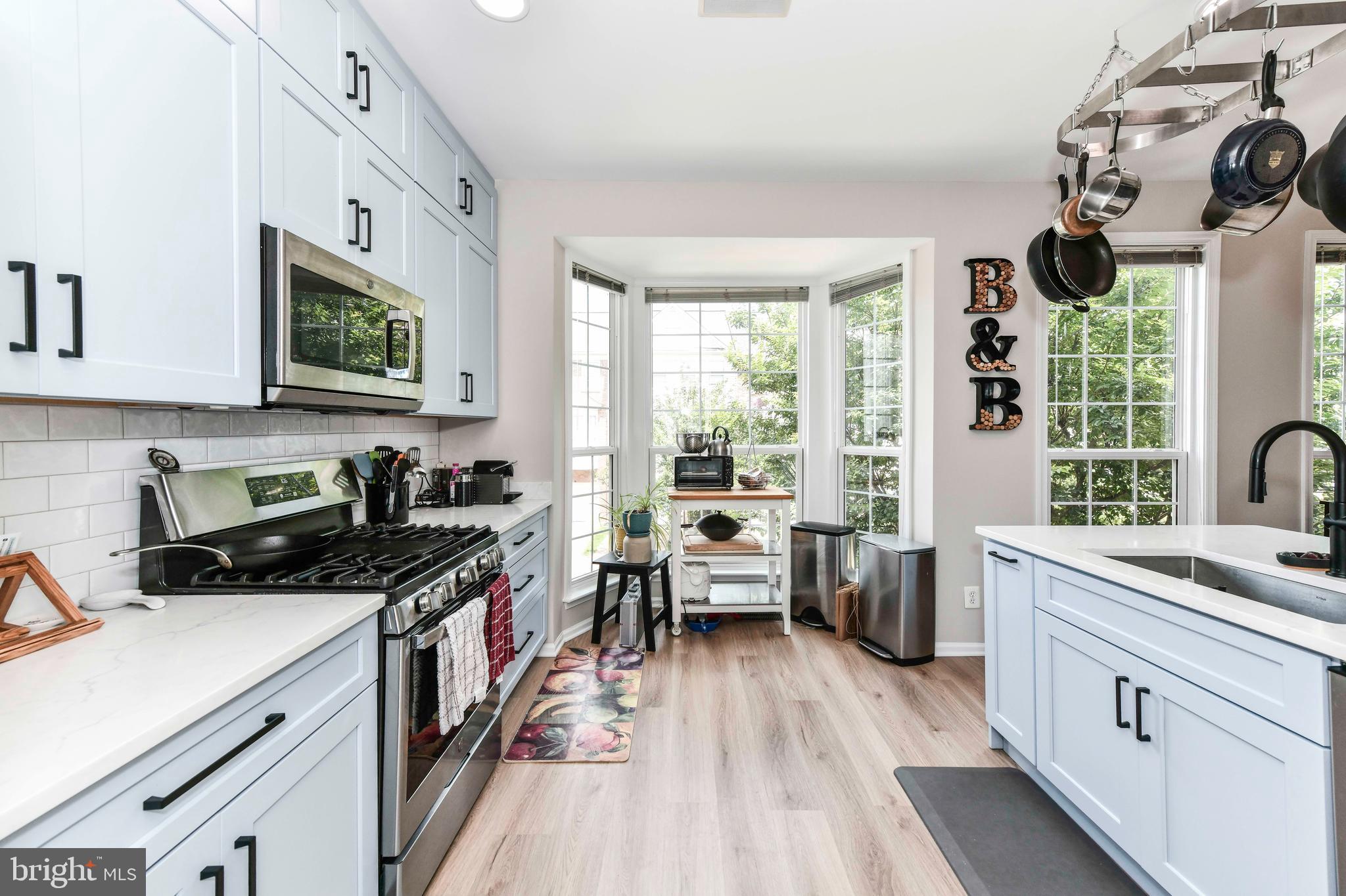 45692 Waterloo Station Square Sterling, VA 20166 - Photo 16 of 31 a kitchen with a sink a stove and wooden floor