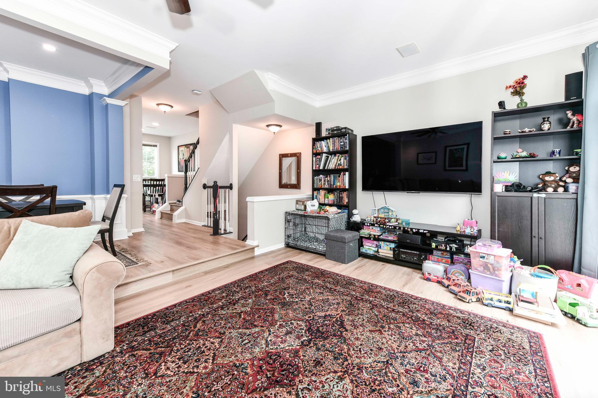 45692 Waterloo Station Square Sterling, VA 20166 - Photo 20 of 31 a living room with furniture and a flat screen tv