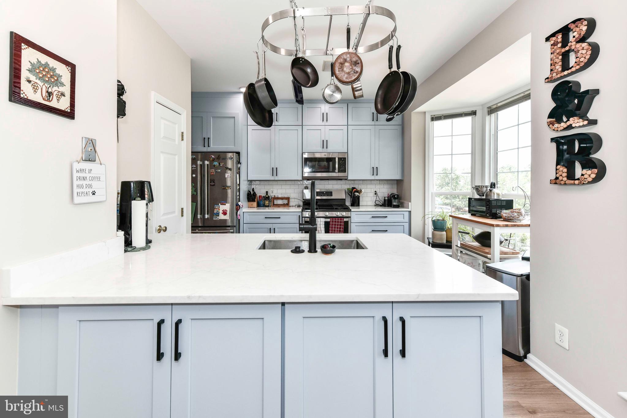 45692 Waterloo Station Square Sterling, VA 20166 - Photo 5 of 31 a kitchen with stainless steel appliances a counter space cabinets and a window