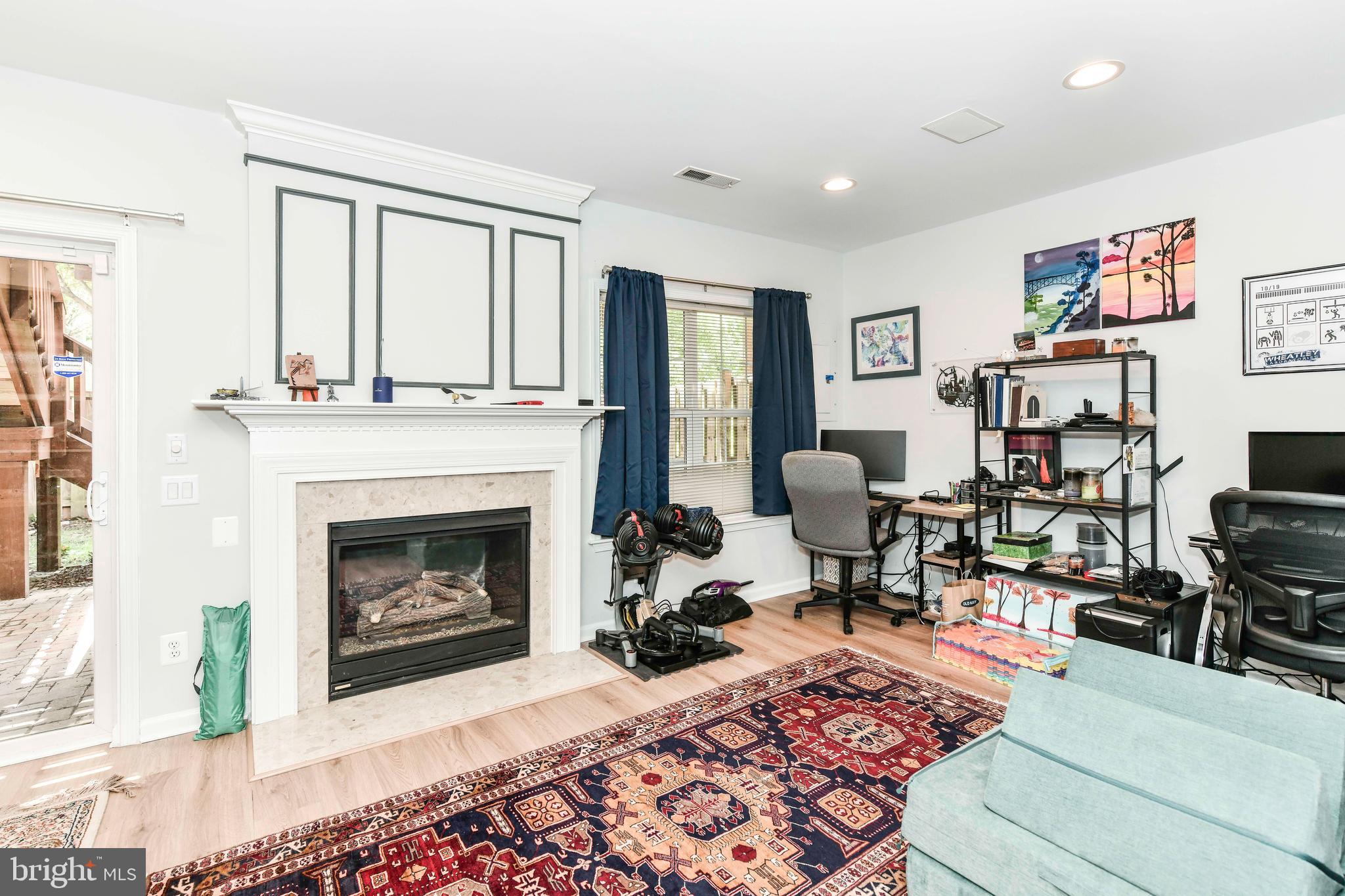 45692 Waterloo Station Square Sterling, VA 20166 - Photo 10 of 31 a living room with furniture a rug and a fireplace