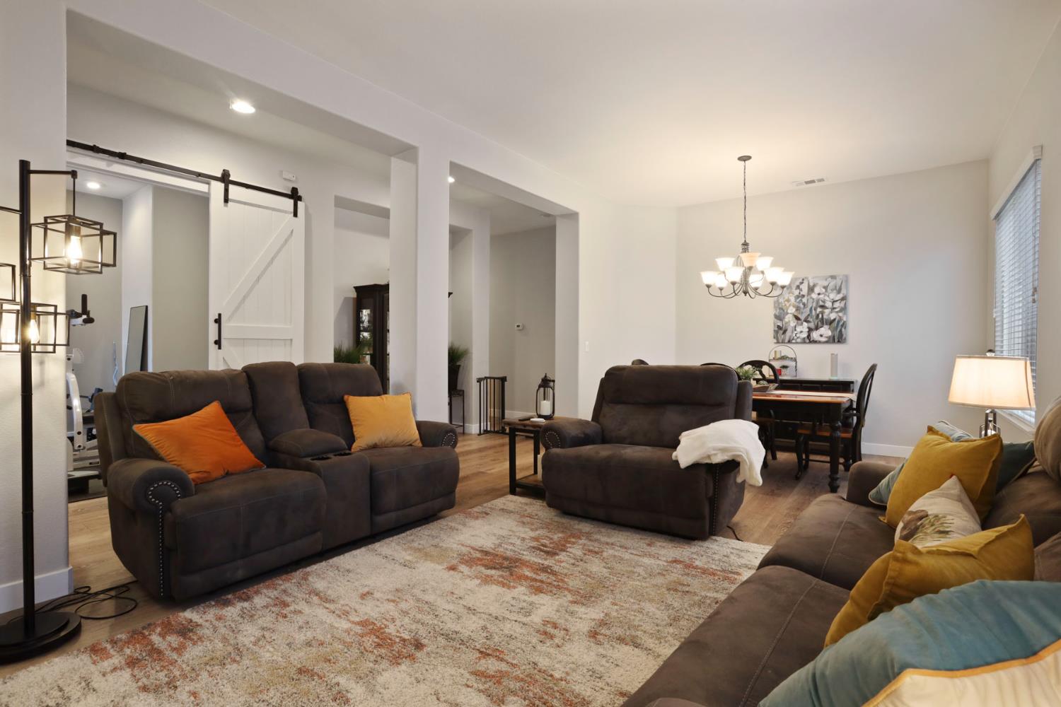 2307 Lighthouse Circle Tracy, CA 95304 - Photo 18 of 57 a living room with furniture and a chandelier