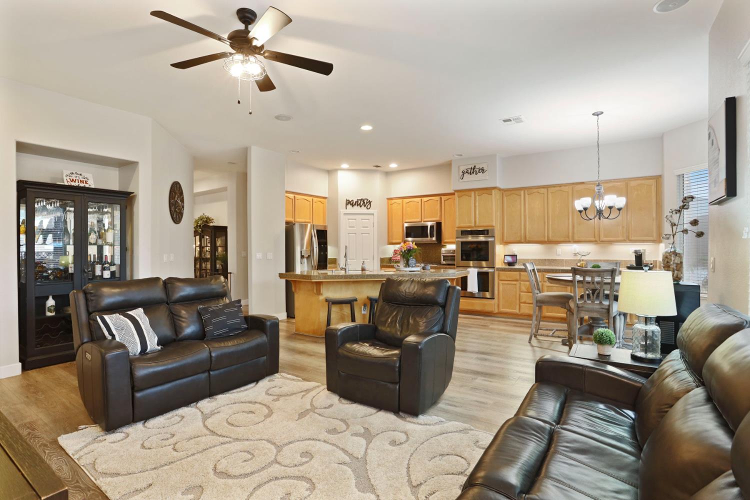 2307 Lighthouse Circle Tracy, CA 95304 - Photo 24 of 57 a living room with furniture kitchen view and a chandelier