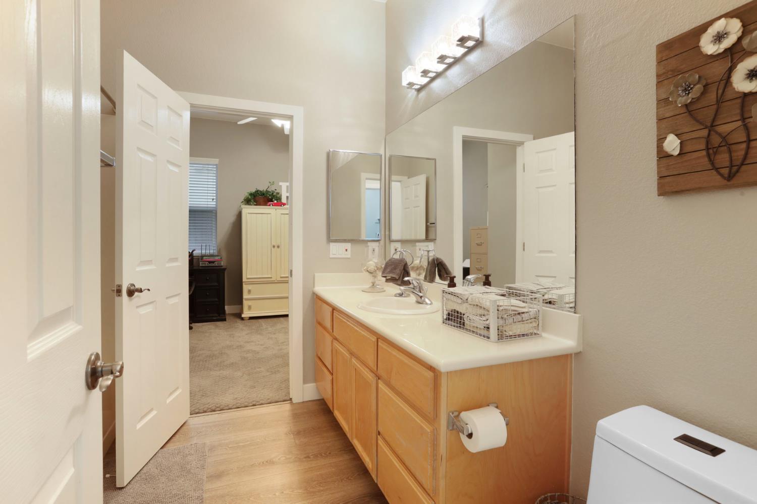 2307 Lighthouse Circle Tracy, CA 95304 - Photo 40 of 57 a bathroom with a sink a mirror and a toilet