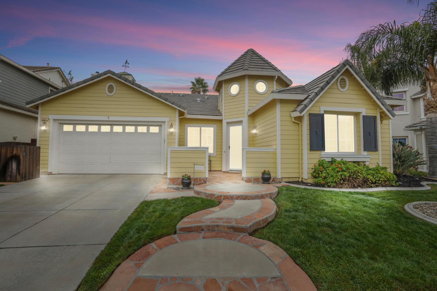 2307 Lighthouse Circle Tracy, CA 95304 - Photo 4 of 57 a front view of a house with a yard and garage