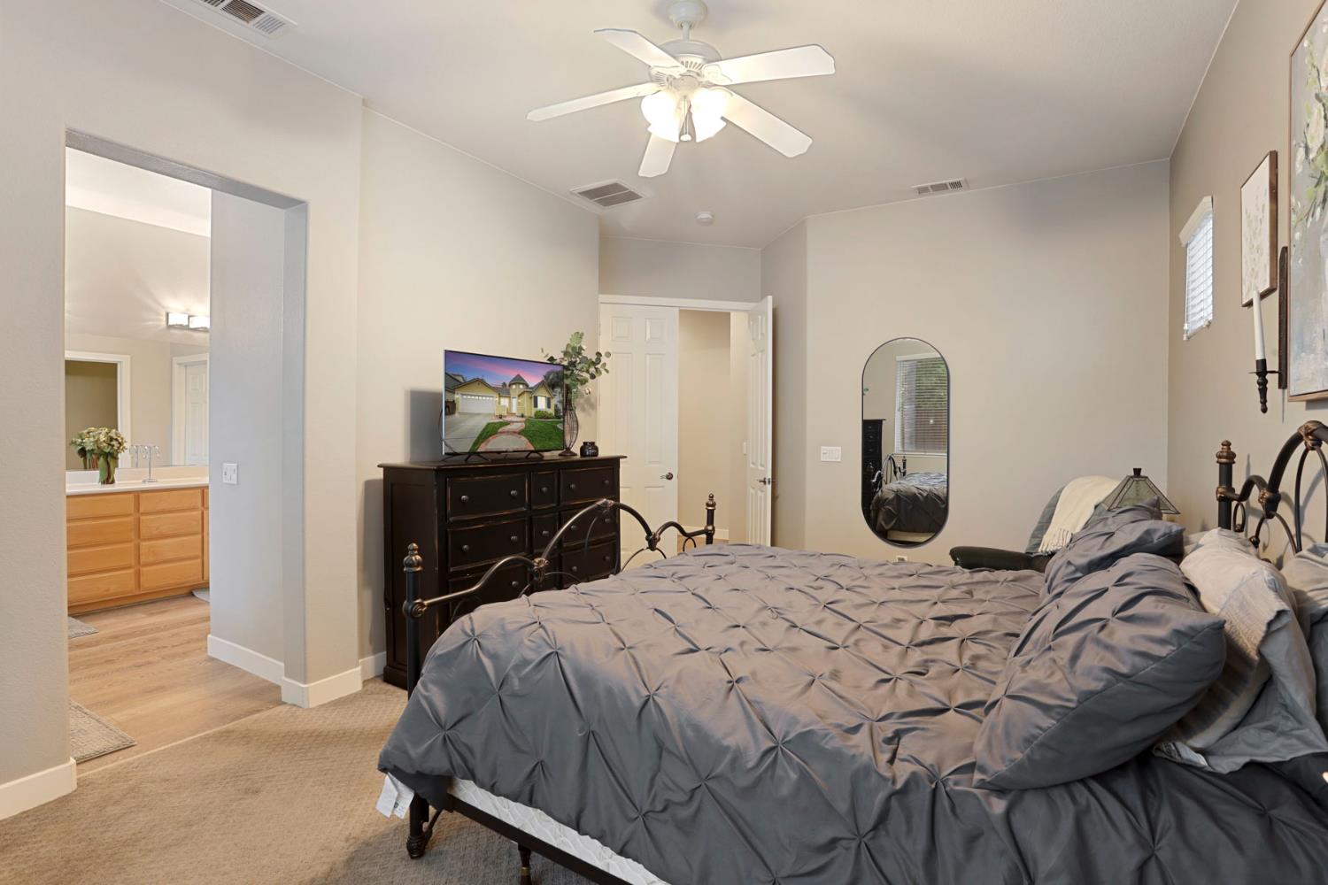 2307 Lighthouse Circle Tracy, CA 95304 - Photo 44 of 57 a bedroom with a bed and a chandelier