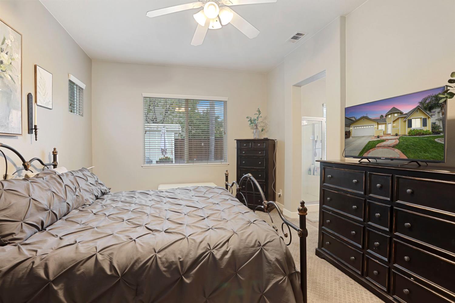 2307 Lighthouse Circle Tracy, CA 95304 - Photo 45 of 57 a bedroom with a bed and a flat tv screen