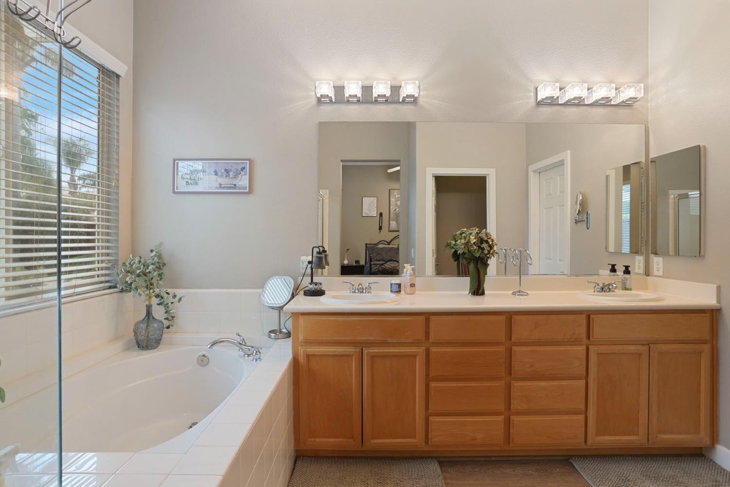 2307 Lighthouse Circle Tracy, CA 95304 - Photo 46 of 57 a bathroom with a tub a sink and mirror
