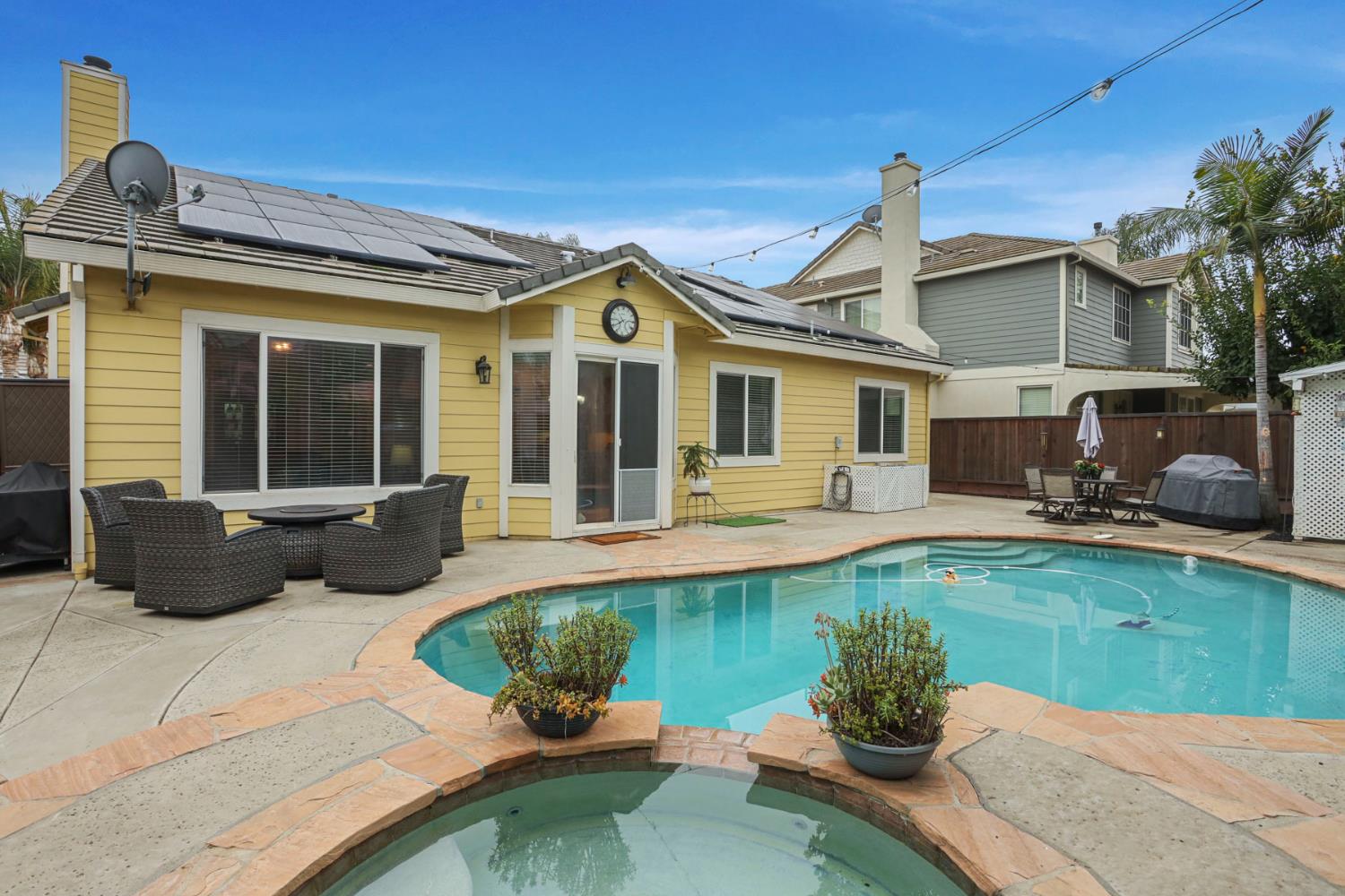 2307 Lighthouse Circle Tracy, CA 95304 - Photo 55 of 57 a front view of a house with swimming pool having outdoor seating