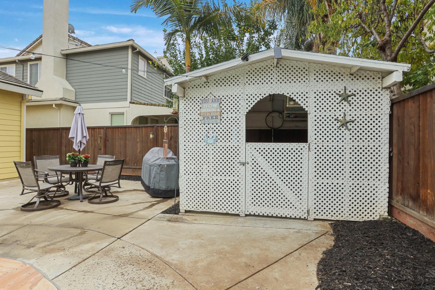 2307 Lighthouse Circle Tracy, CA 95304 - Photo 56 of 57 a view of a patio with a table and chairs and potted plants