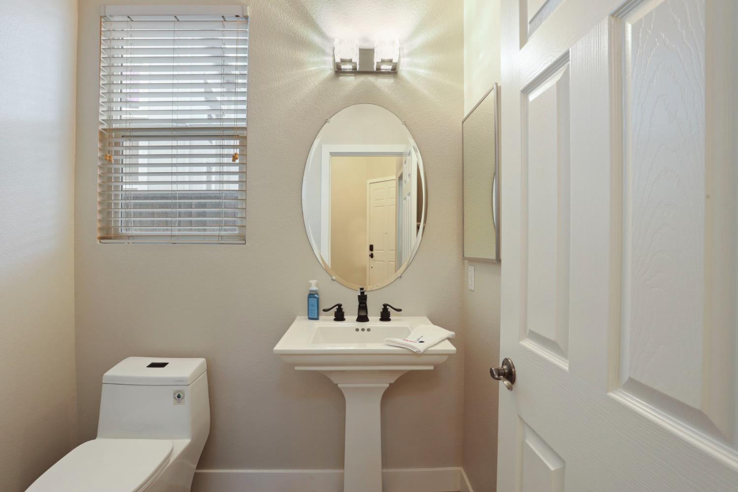 2307 Lighthouse Circle Tracy, CA 95304 - Photo 9 of 57 a bathroom with a toilet sink and mirror