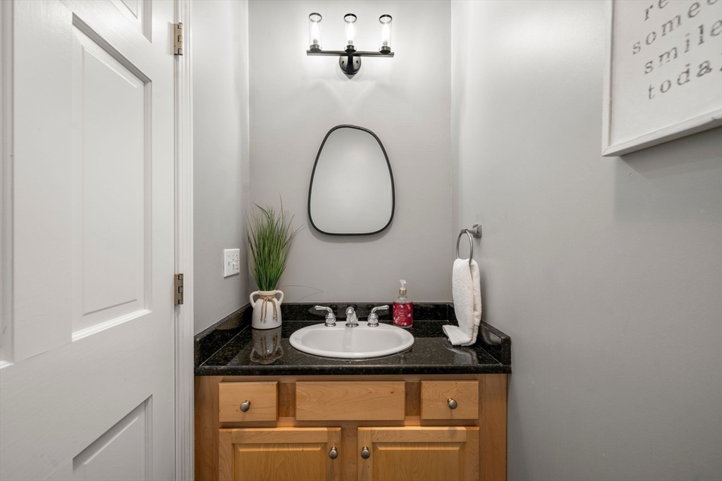 34 Wood Duck Road Acushnet, MA 02743 - Photo 16 of 23 a bathroom with a granite countertop sink and a mirror