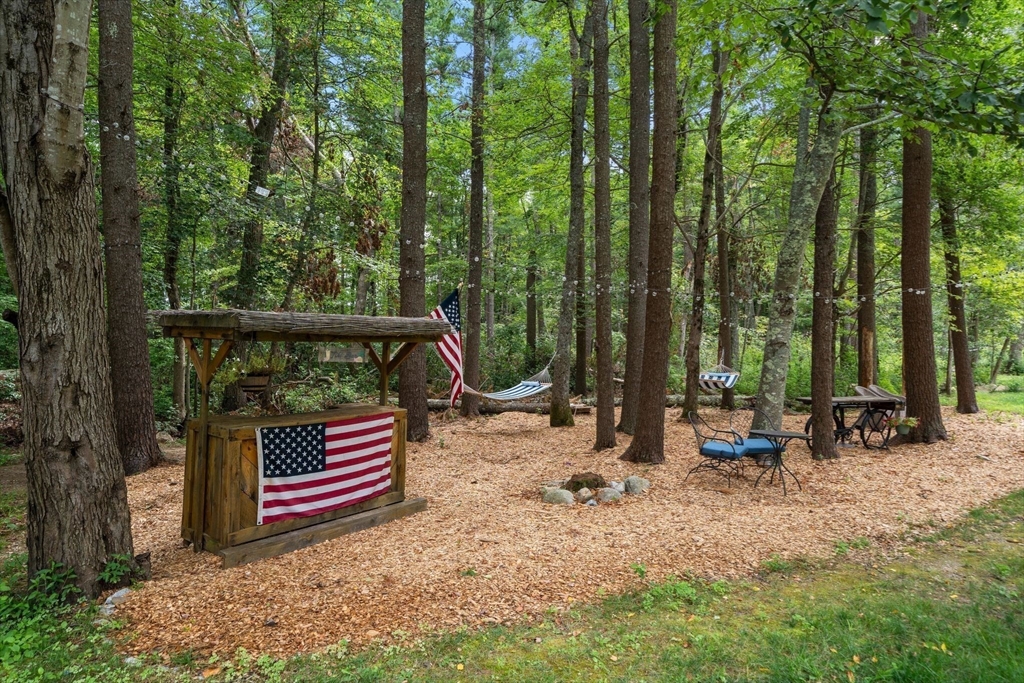 34 Wood Duck Road Acushnet, MA 02743 - Photo 20 of 23 a wooden bench sitting in the middle of a forest