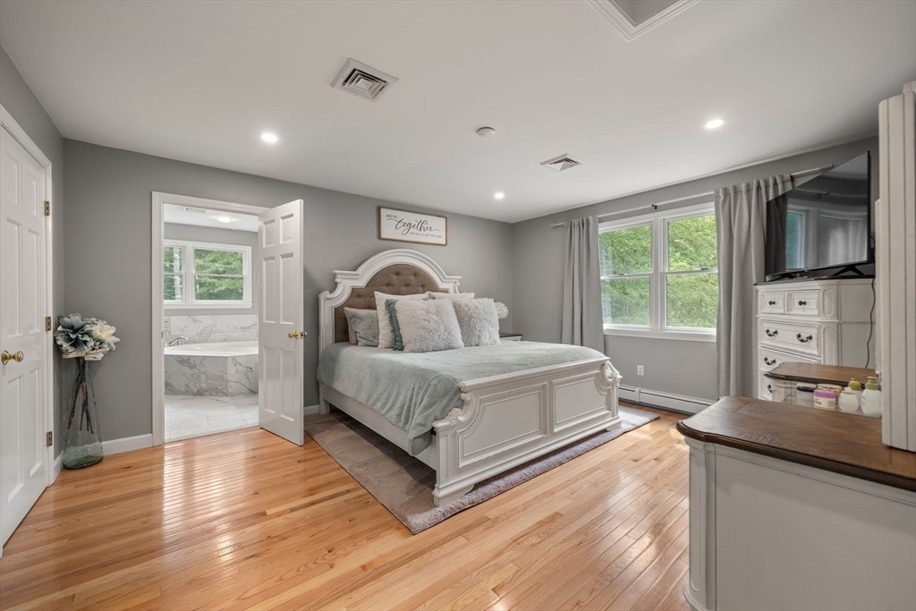 34 Wood Duck Road Acushnet, MA 02743 - Photo 9 of 23 a spacious bedroom with a bed and a large window
