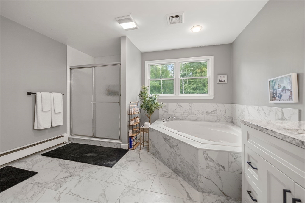 34 Wood Duck Road Acushnet, MA 02743 - Photo 10 of 23 a bathroom with a granite countertop tub a sink and a shower