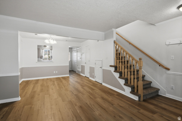794 East 950 S Street Provo, UT 84606 - Photo 5 of 28 Open-concept living area with wood-finish flooring, two-tone painted walls, and crown molding