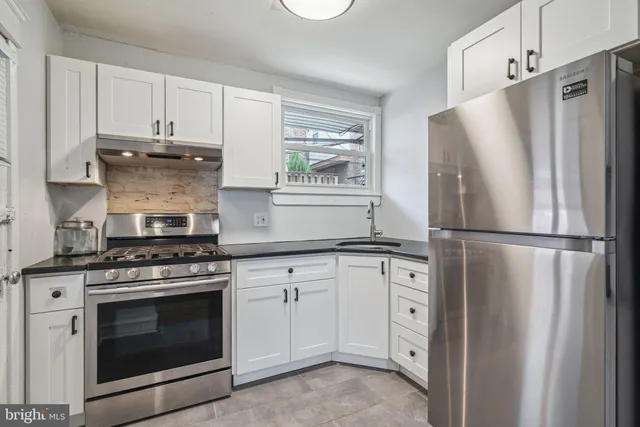 a kitchen with cabinets and stainless steel appliances
