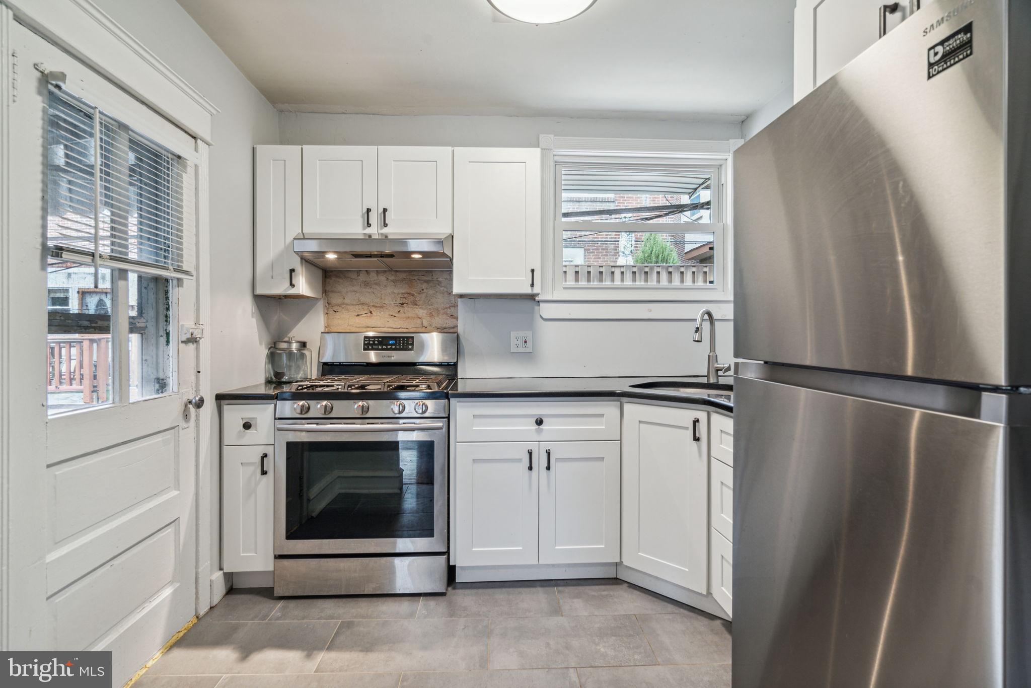3455 Tilden Street Philadelphia, PA 19129 - Photo 12 of 32 a kitchen with cabinets and stainless steel appliances