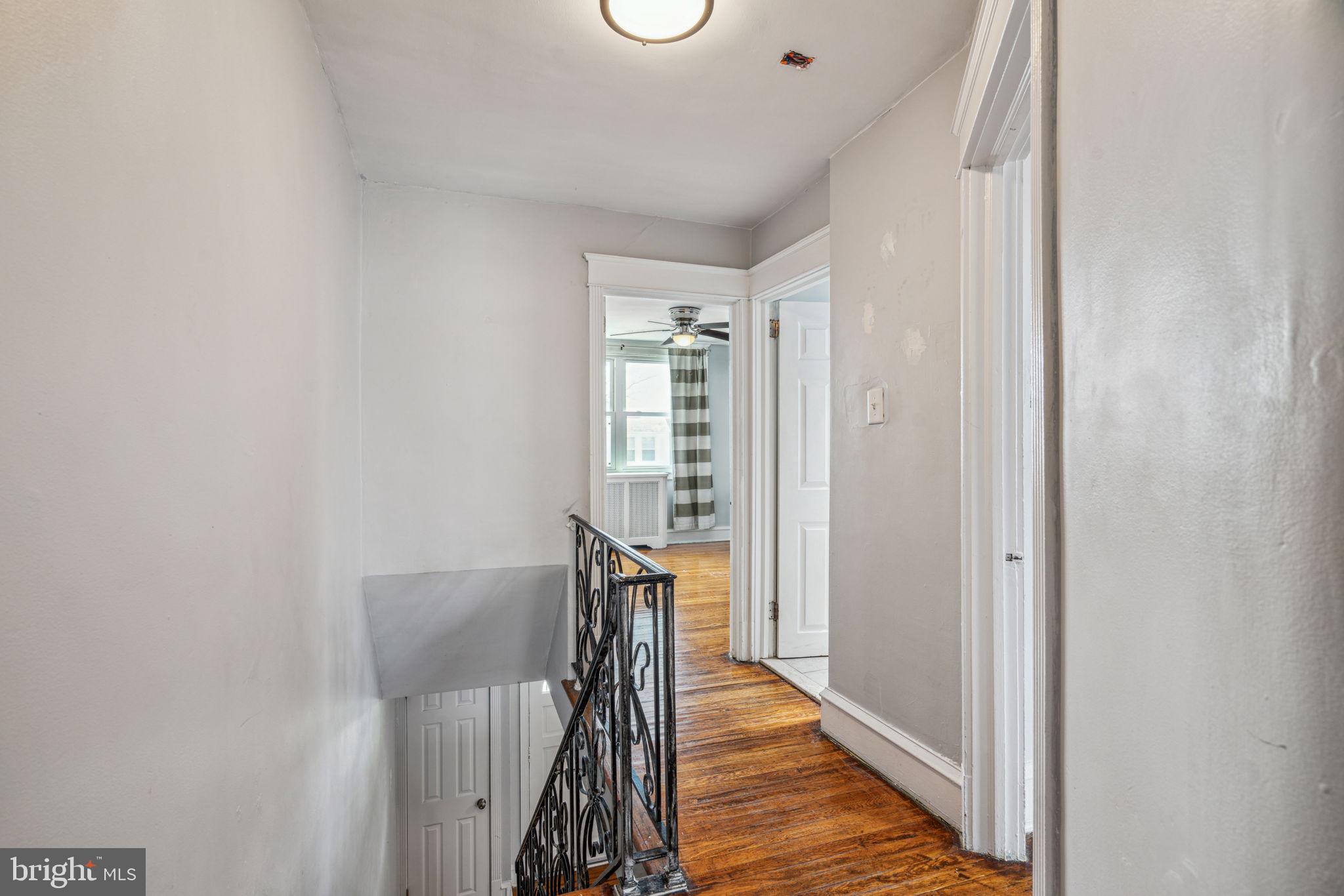 3455 Tilden Street Philadelphia, PA 19129 - Photo 15 of 32 a view of a hallway with wooden floor and staircase