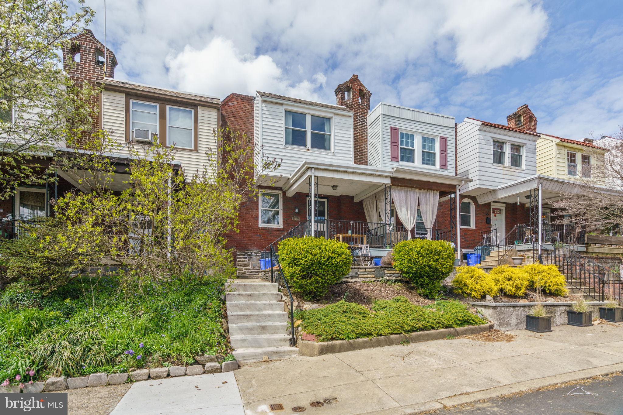 3455 Tilden Street Philadelphia, PA 19129 - Photo 2 of 32 front view of a brick house with a yard