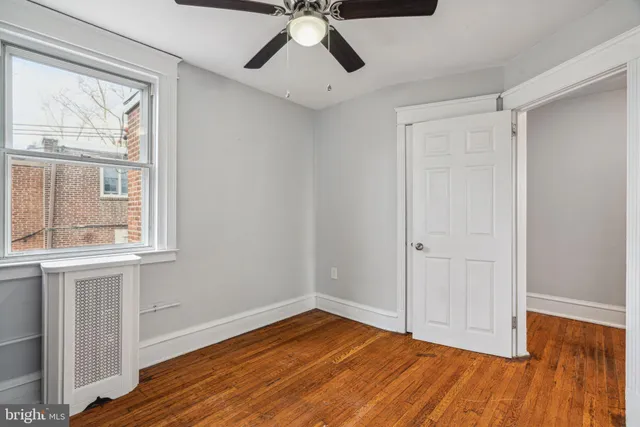 a view of room with window and book shelf
