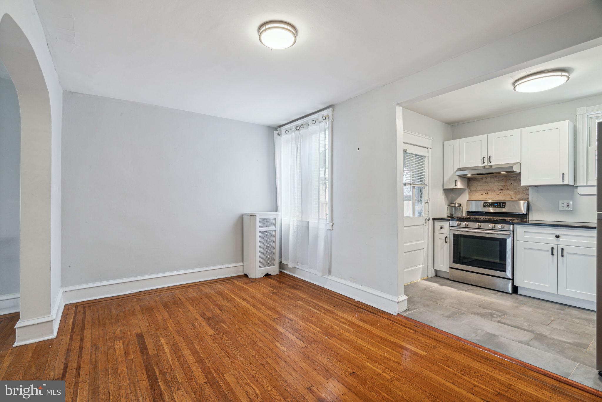3455 Tilden Street Philadelphia, PA 19129 - Photo 8 of 32 a kitchen with granite countertop a stove and a refrigerator
