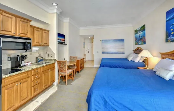 a large bedroom with bed and a window