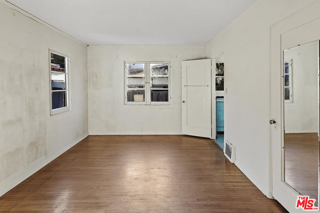 266 Mabery Road Santa Monica, CA 90402 - Photo 16 of 29 a view of an empty room with wooden floor and a window