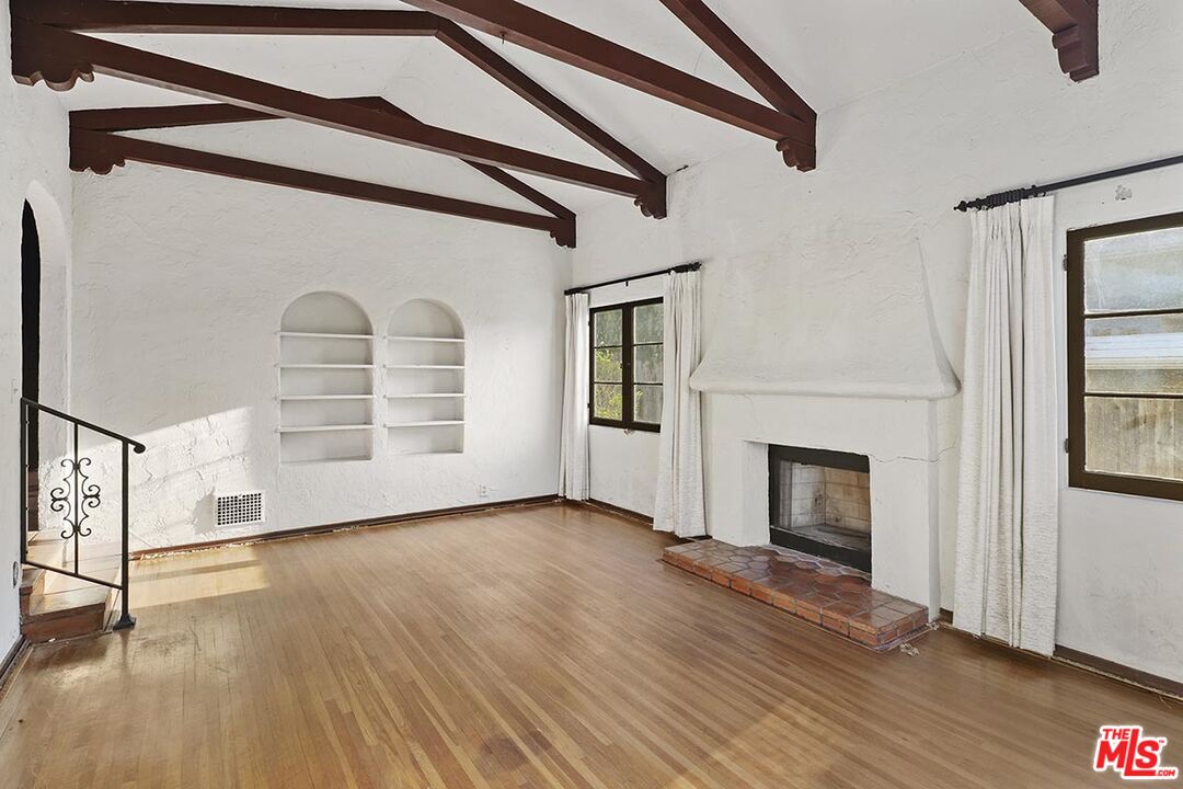 266 Mabery Road Santa Monica, CA 90402 - Photo 5 of 29 a view of empty room with wooden floor and fireplace