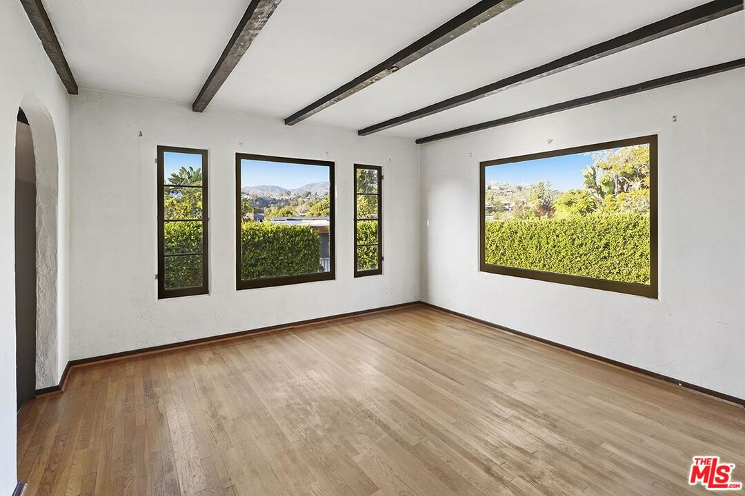 266 Mabery Road Santa Monica, CA 90402 - Photo 10 of 29 a view of an empty room with wooden floor and a window