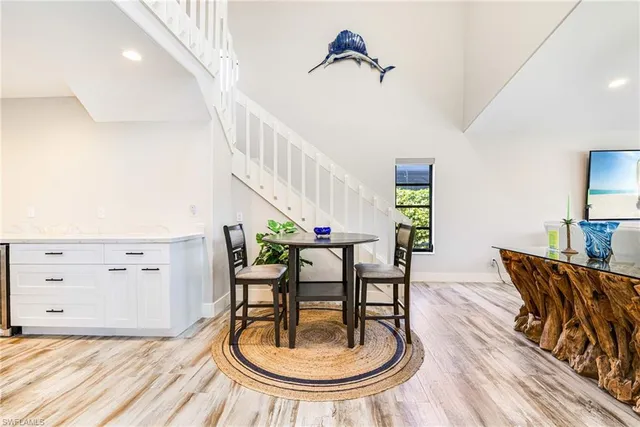 a living room with furniture a potted plant and a rug