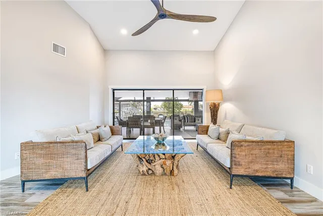 a bedroom with a bed and a large mirror next to a window