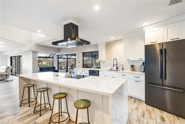 a kitchen with stainless steel appliances a stove and cabinets