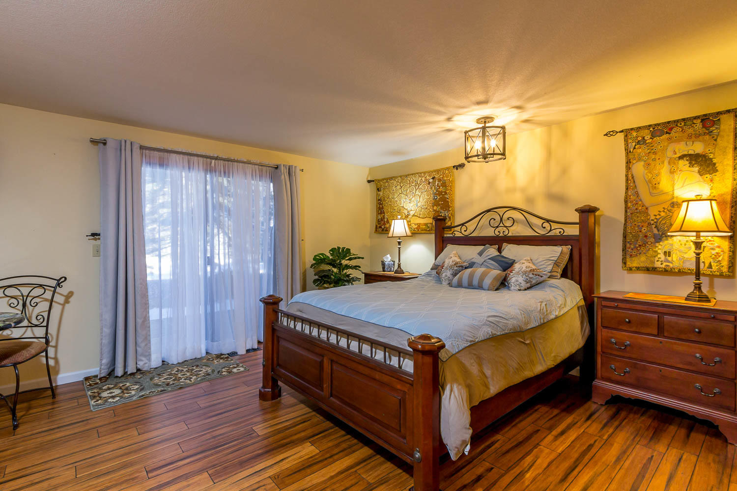 17704 Rogue Lane Sunriver, OR 97707 - Photo 17 of 26 a bedroom with a bed and wooden floor