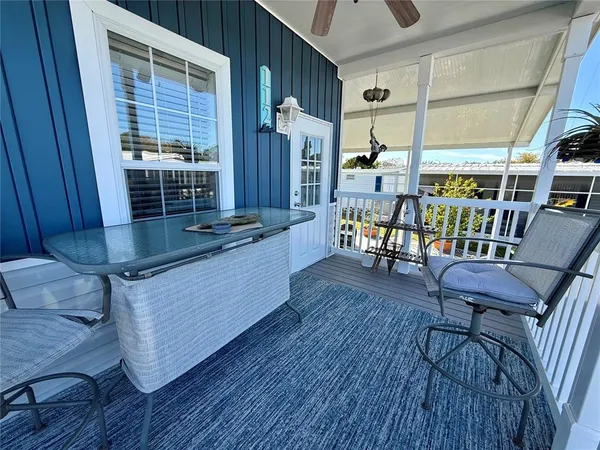 a view of a deck with table and chairs with wooden floor and fence