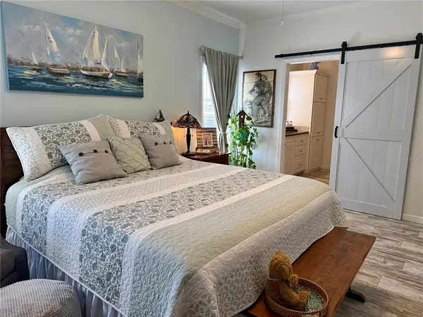 a bedroom with a bed and a television