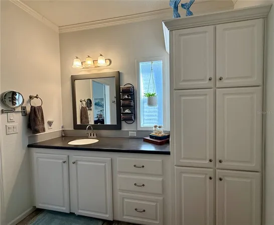 a hallway with a sink and a mirror