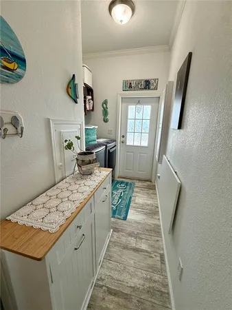 a kitchen with a stove and a wooden floor