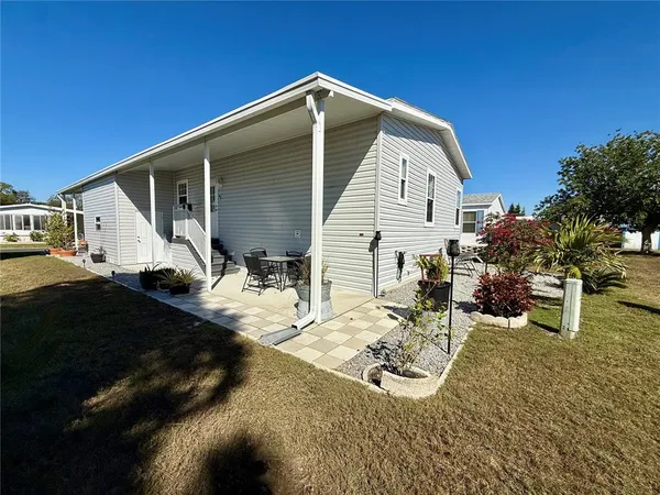 a view of a backyard with plants and a patio