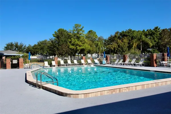 a swimming pool view with a outdoor seating