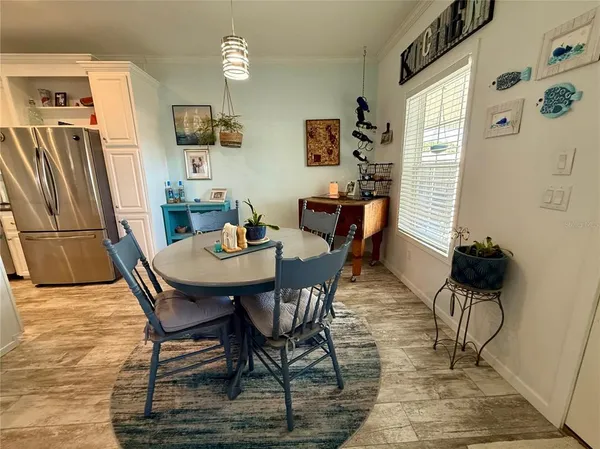 a dining room with furniture a window and kitchen view