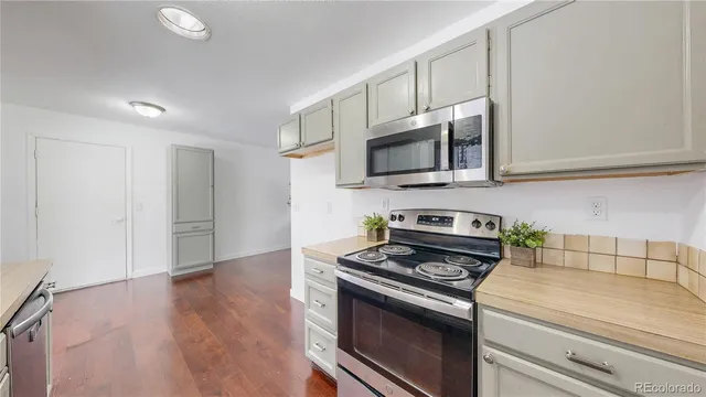 a kitchen with granite countertop a stove and a microwave