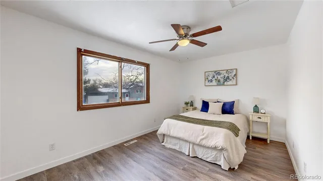 a bedroom with a bed and a painting on the wall
