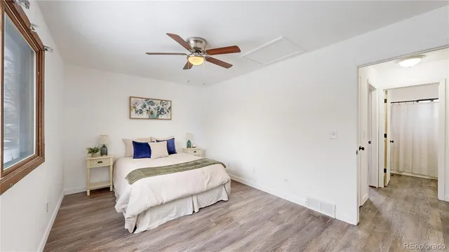 a bedroom with a bed and wooden floor