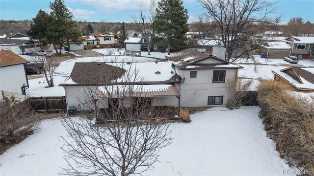 an aerial view of residential houses with city view