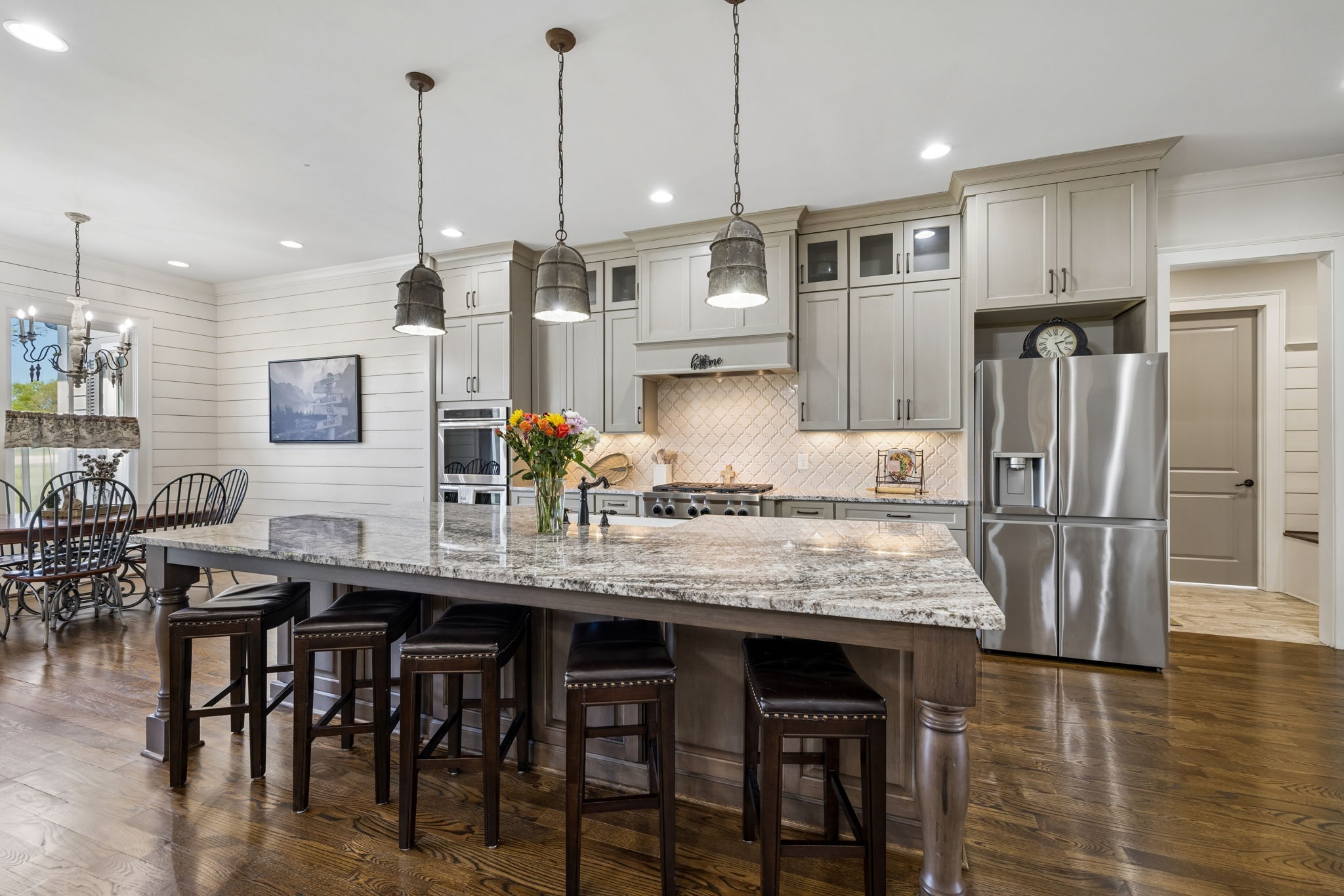 6033 Native Pony Trail College Grove, TN 37046 - Photo 26 of 87 a kitchen with stainless steel appliances granite countertop a kitchen island and chairs in it