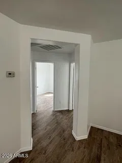 a view of hallway with wooden floor