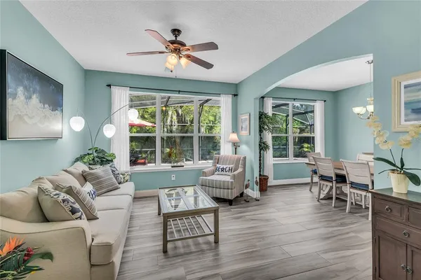 a kitchen with stainless steel appliances granite countertop a stove top oven a sink dishwasher a dining table and chairs with wooden floor