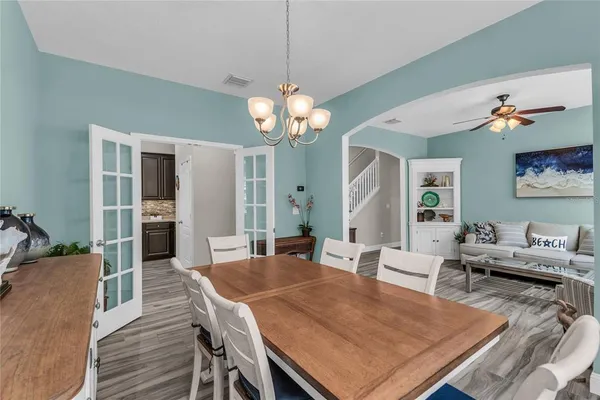 a view of a patio with a table and chairs under an umbrella